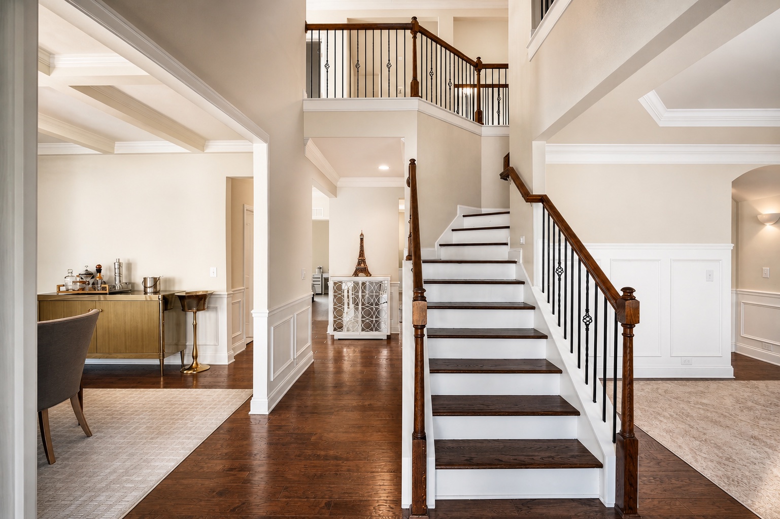 Two-story foyer with wood staircase